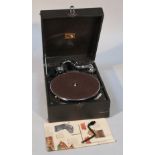 A HMV gramophone, the textured black leather case hinging to reveal a part chrome finish interior,