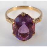 An amethyst dress ring, the lozenge shaped claw set stone, in a part pierced shank, yellow metal