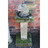 A 20thC stone column bird bath, the square top on a rectangular support terminating in a square