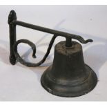 An early 20thC iron school bell, with a shaped bracket of circular trumpet shaped form, the whole,