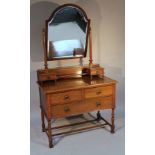 An Edwardian oak dressing table, with fitted mirror, glass galleried back and two short over a