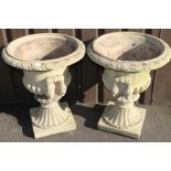 A pair of Victorian style campana garden urns, the inverted bodies part gadrooned and flanked by