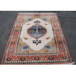 A Kabir rug, of geometric pattern in cream, blue and red, 141cm wide.