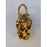A nugget pendant, unmarked yellow metal, 3cm high, 7.4g all in.