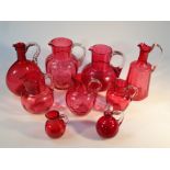 Various Victorian cranberry glass, to include a jug of ribbed form, with shaped handle on circular