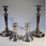 A pair of silver plated candlesticks, of circular form, with acanthus leaf banded dish holders, on