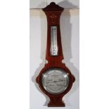 An Edwardian mahogany and boxwood strung two dial barometer and thermometer, fitted in a carved case