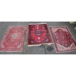 An Iranian rug, in geometric pattern predominately in red, cream and blue, 110cm wide, and two