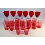 Various cranberry drinking glasses, to include beakers of tapering cylindrical form, 9.5cm high, and