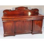 A Victorian mahogany sideboard, with a fixed scroll cornice above three cushion drawers and a double