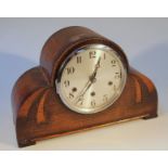 A 1950's oak cased mantel clock, the circular 15cm dial with Arabic numerals revealing a key wind