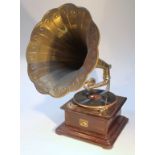 An early 20thC HMV gramophone, with brass horn of shaped floral form with chrome mounts on an