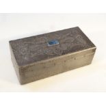 An early 20thC Arts and Crafts pewter cigarette box, the rectangular hinged lid, repoussé