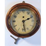 An early 20thC bulk head clock, the brass mounted 15cm dia. dial with Roman numerals and