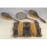 A George V silver dressing table set, by Hasset & Harper Ltd, comprising of a tray of shaped