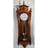 A 20thC walnut cased Vienna wall clock, the circular 18cm dia. dial with Roman numerals and