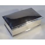 A George V silver cigarette case, of rectangular form with a domed lid hinging to reveal a