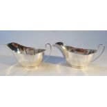 A pair of George VI silver sauce boats, by Barker Brothers Ltd, of shaped form with 'C' scroll