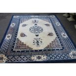A Chinese carpet, of floor standing rectangular form, geometrically decorated with flowers and