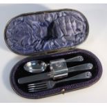 A George V cased silver cutlery set, by Wakely & Wheeler comprising knife, fork, spoon and napkin