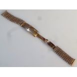 A 9ct gold watch strap, of part mesh work design, 21cm long fully extended, 27.5g.