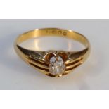 An 18ct gold diamond solitaire ring, the textured part pierced shank, claw set with a central stone,