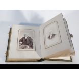 A late Victorian photograph album, raised leather boards with metal clasps and a number of