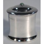 An Edwardian silver jar and cover, by William Comyns, the domed lid with green orb knop, with a