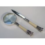 A presentation magnifying glass and paper knife, with resin and white metal handles, each headed