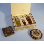 A boxed set of Hermes Caleche perfume, comprising three bottles, together with a powder compact with