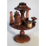 A late 19thC mahogany sewing stand, the pin cushion centre on a floral dish holder above baluster