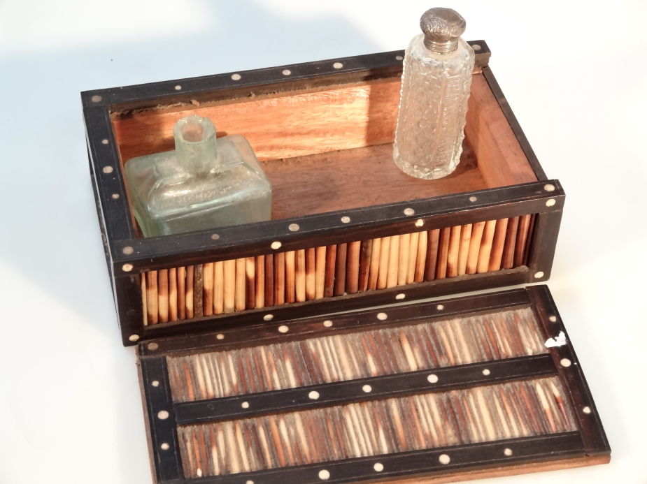 An early 20thC porcupine quill box, with an ebonised border, the slide top revealing a plain - Image 2 of 2
