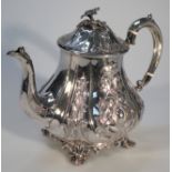 A Victorian silver teapot, by the Harrison Brothers, the waisted body repoussé decorated and