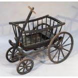 An ebonised wooden child's carriage, the spindle top with plain rails, on a sleigh base,