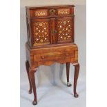 A mother of pearl and bone inlaid cabinet, centred with a side profile of a gentleman, surrounded by