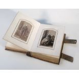 A late Victorian photograph album, with pressed leather boards and metal clasps, 15.5cm high, a