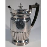 A George VI silver water jug, by Mappin & Webb, with a shaped spout the compressed domed lid with