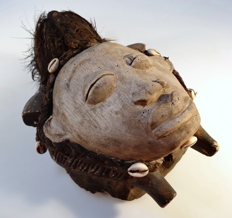 A Gabon African tribal mask, the carved wooden central face, with feathered and shell head dress, - Image 2 of 4