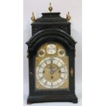 A George III ebonised bracket clock, the brass and silvered arched dial signed John Wood,