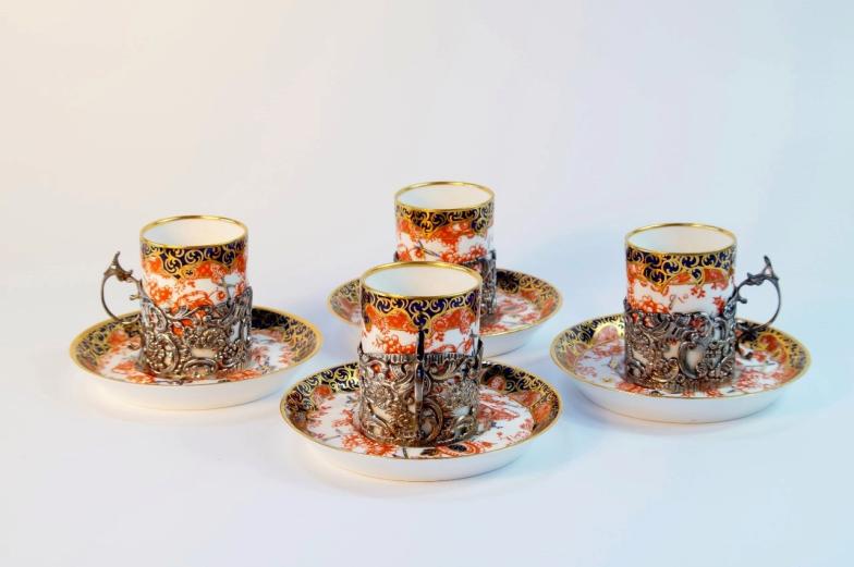 A set of four Royal Crown Derby coffee cannisters, with pierced silver floriate holders (London