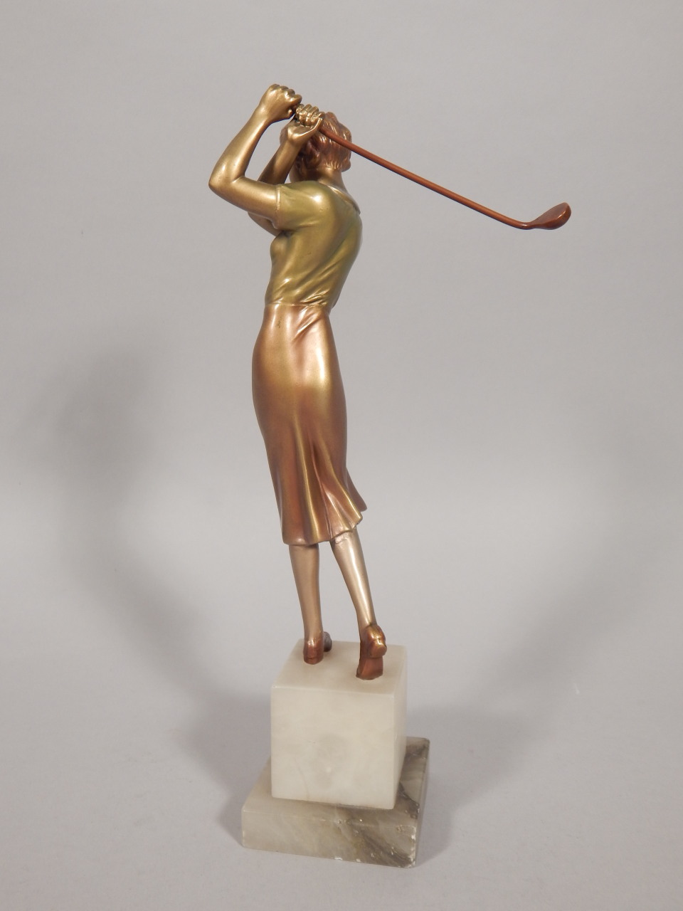 An Art Deco cold painted bronze figure of a female golfer, on a stepped onyx base, unmarked, 26cm - Image 2 of 2