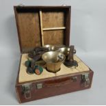 A Set of eight hand bells, made by Mears of London, each with leather strap, and in an adapted case.