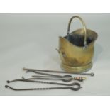 A brass helmet shaped coal scuttle, fire tongs, etc.