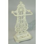 A Victorian style cast iron umbrella stand, decorated with lizard type figures, roundels, etc,