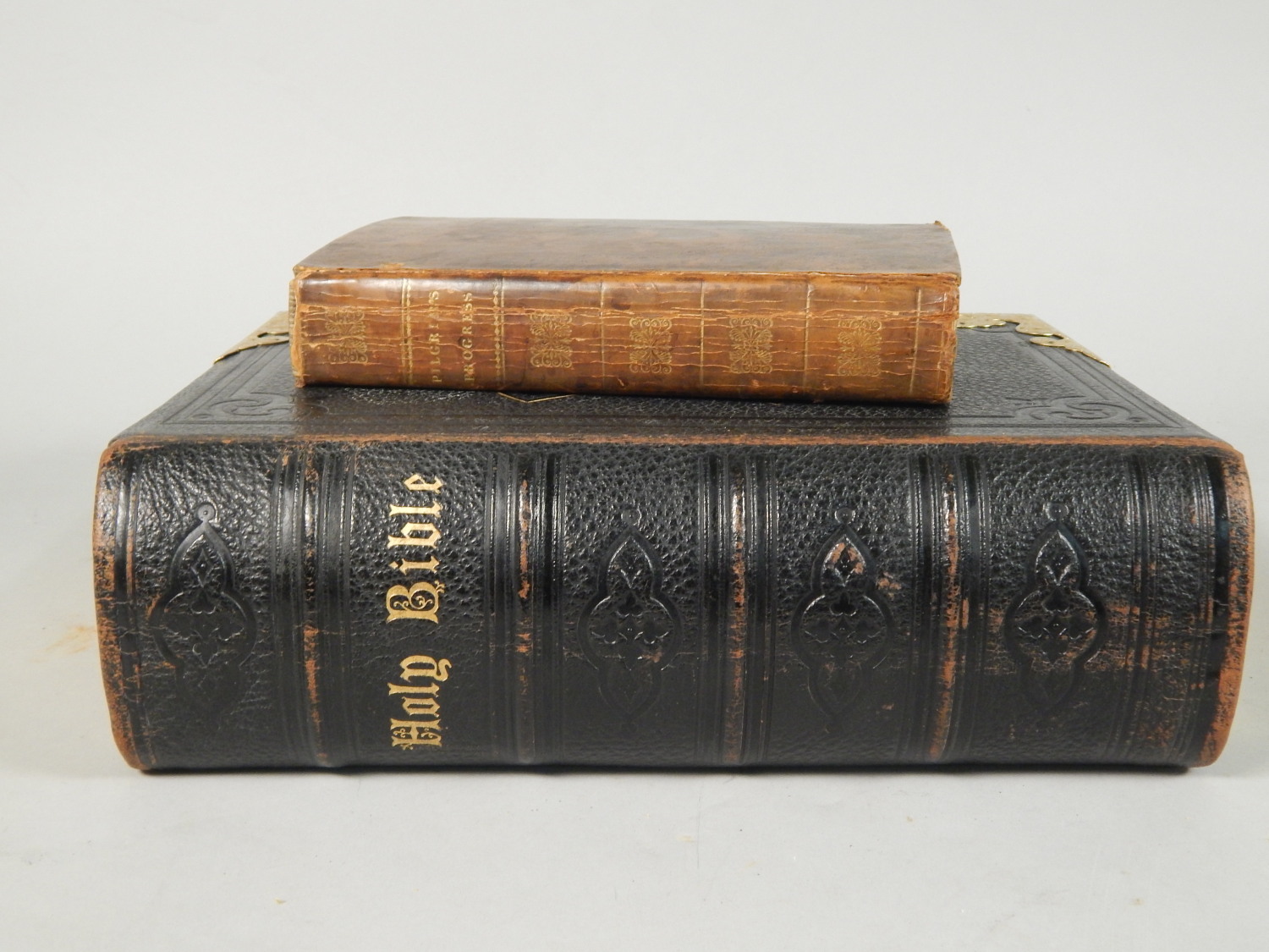 Illustrated Holy Bible, leather binding and brass clasp, and a copy of Pilgrims Progress from 1824.