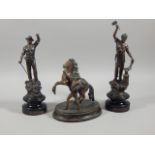 Three items of early 20thC spelter, a pair of figures, Le Forgeron and Le Mineur, and a small Marley