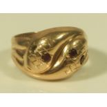 A 9ct gold snake ring, with garnet eyes (one missing), 4.6g all in.