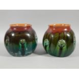 A pair of Linthorpe pottery globular vases, designed by Dr Christopher Dresser, each with raised