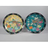 A pair of oriental porcelain chargers, each similarly decorated with Asiatic pheasants on yellow and