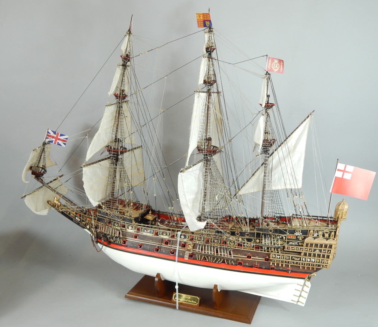 A scale model of HMS Sovereign of the Seas, on a fitted base, with accompanying magazines.